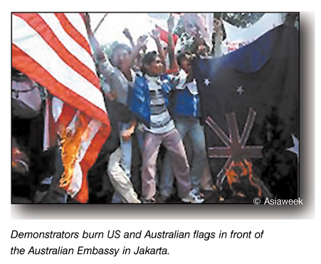 Demonstrators burn U.S. and Australian flags